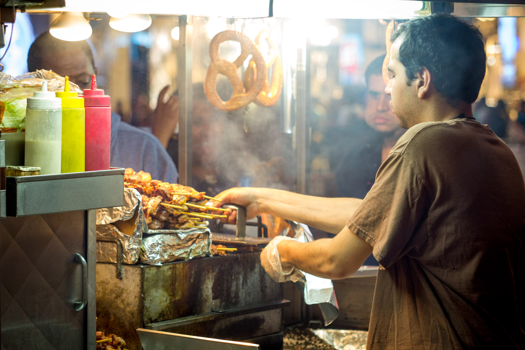 A chef makes food at a food cart in NYC